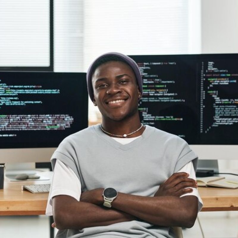 happy-young-successful-it-engineer-casualwear-looking-you-while-sitting-by-workplace-against-c_622301-5572 happy-young-successful-it-engineer-casualwear-looking-you-while-sitting-by-workplace-against-c_622301-5572