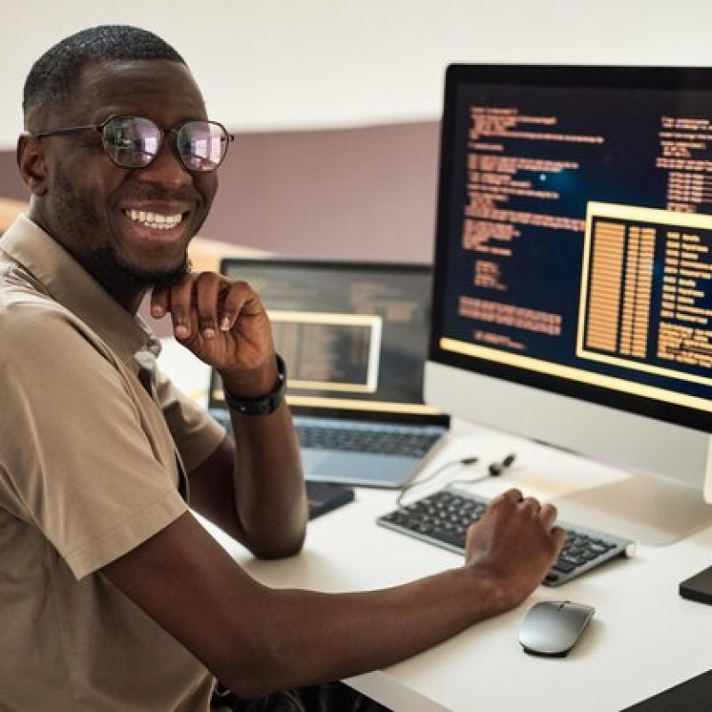 portrait-joyful-software-developer-glasses-programming-computer_236854-46018