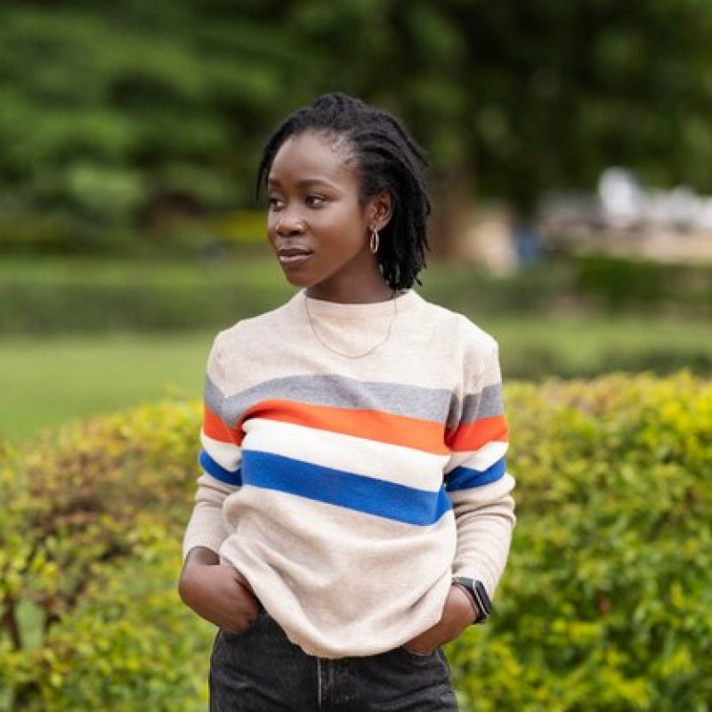 portrait-young-woman-with-afro-dreadlocks-posing-outside_23-2149451619